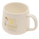 Cream stoneware mug with gold "30" and "Sparkle" script, an illustrated figure holding a star and heart balloon, "New Rules, New Adventures" text, on a plain white background.