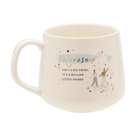 White stoneware mug with C-handle, printed with "Friendship isn't a big thing, it's a million little things" in gold script, featuring two figures and a heart balloon on a plain white background.