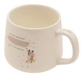 White stoneware mug with cream interior, printed Fun and Fabulous Friends Make Life Better in gold script over a purple brushstroke, with friends illustration and gold stars.