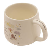 Cream stoneware mug with gold "Nan" lettering, two bears on a branch under a moon and pastel clouds, "Love you so very much" inscribed inside the handle, on a white background.