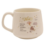 Cream stoneware mug with handle, featuring "Nan" in gold script, a hug message, two bears on a branch, pastel clouds and a gold crescent moon, shown on a white background.