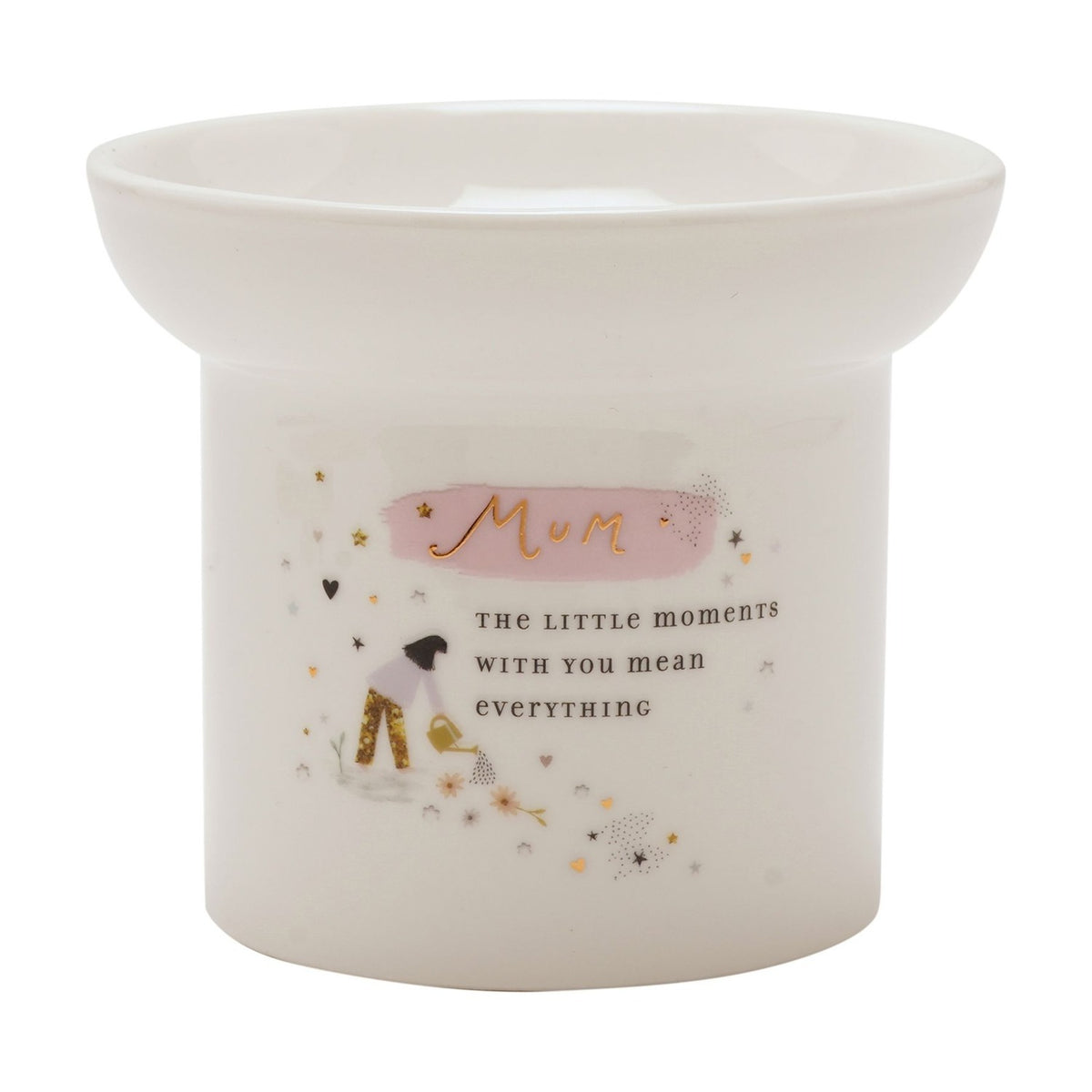 White round ceramic wax melt burner with gold "Mum" lettering on pink brushstroke, a woman watering flowers illustration, gold stars and hearts, on a plain background.