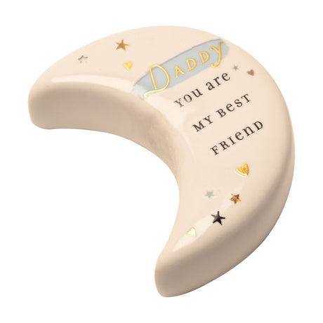 White ceramic crescent moon keepsake token reading "Daddy, you are my best friend" in gold and dark lettering with star and heart details, on a plain background.