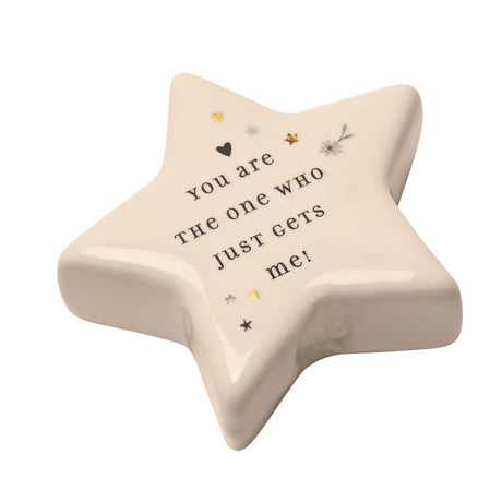 White ceramic star keepsake token with glossy finish, printed with "You are the one who just gets me!" and small heart, star, and flower motifs, on a plain white background.