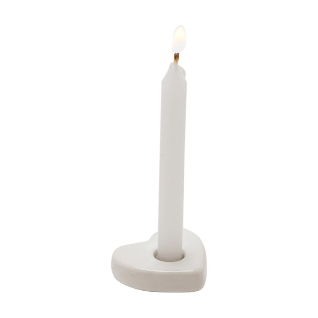 Shine Bright mini white candle lit and standing in a flat, rounded white heart-shaped holder with a single socket, shown against a plain white background.