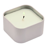 Birthday Wish Square Tin Scented Candle 125g in white, showing a lit wick and pale wax inside a rounded square purple-grey tin, on a plain white background.