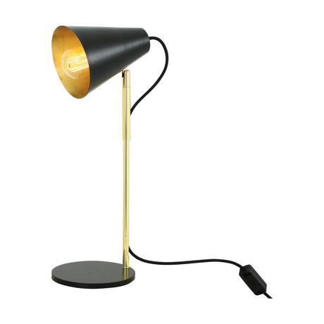 Lusaka mid-century table lamp with a matt black cone shade on a slim polished brass stem and round black base, E27 bulb lit, on a white background.