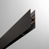 Close-up of the Luxeon 2m Up & Down Magnetic Track in black, showing the tall rail's end profile with internal copper conductor strips, set against a plain light grey background.