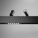 Luxeon 2m Up & Down Magnetic Track in black, a narrow rail with built-in LED strip and two cylindrical spotlights attached, shown against a plain grey background.
