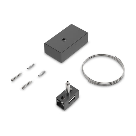 Luxeon track ceiling rose kit in black, with rectangular rose, coiled steel suspension wire, gripper connector, screws and wall plugs on a white background.