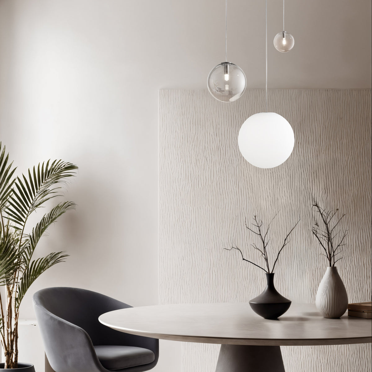 Lyria 30cm globe glass light shade in satin white pendant over a dining table, paired with a smaller clear glass globe pendant in a neutral-toned room.