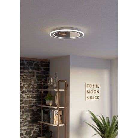 Macchioni LED flush ceiling light in white, round design with outer ring, fitted in a hallway ceiling above a bookshelf and "To the Moon & Back" wall art.