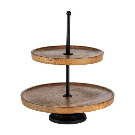 Makilala Cake Stand in Natural, a two-tier round mango wood stand with raised rims and a slim black metal pole and foot, shown on a plain white background.