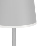 Close-up of the Mannera-L LED floor lamp in grey, showing the dome-shaped plastic shade with a white rim edge atop a slender aluminium and steel stem, on a plain white background.