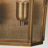 Close-up of the Mansion 2 Light Outdoor Wall Light in aged brass, featuring a vintage-style design with a clear glass enclosure that displays a single bulb. The brushed texture of the solid brass imparts a warm, antique look, making it perfect for IP44 rated outdoor lighting applications.
