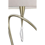 Close-up of the Mara 4 Light Floor Lamp in antique brass, featuring a curved arm, ivory white pleated shade, and an elegant clear crystal pendant hanging from the center.