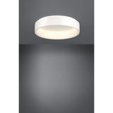 Marghera 1 LED flush ceiling light, 59.5cm round white drum with integrated diffuser, shown illuminated on a grey ceiling and wall in a plain studio setting.