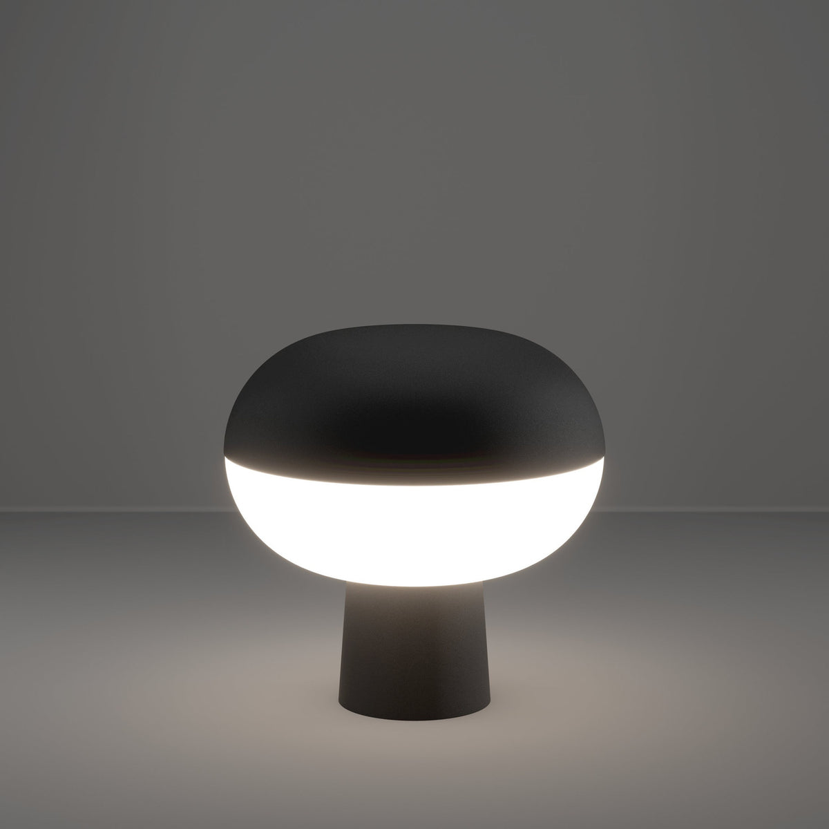 Marini Smart Colour Changing LED Table Lamp in matt black, mushroom-shaped with domed top and glowing white band on a slim tapered base, shown lit against a plain grey background.