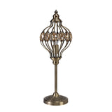 The Marisa 1 Light Crystal Table Lamp features an antique brass finish, a round base, and an ornate metal cage shade adorned with oval amber crystals, capturing the charm of a Middle Eastern lantern in an elegant design.