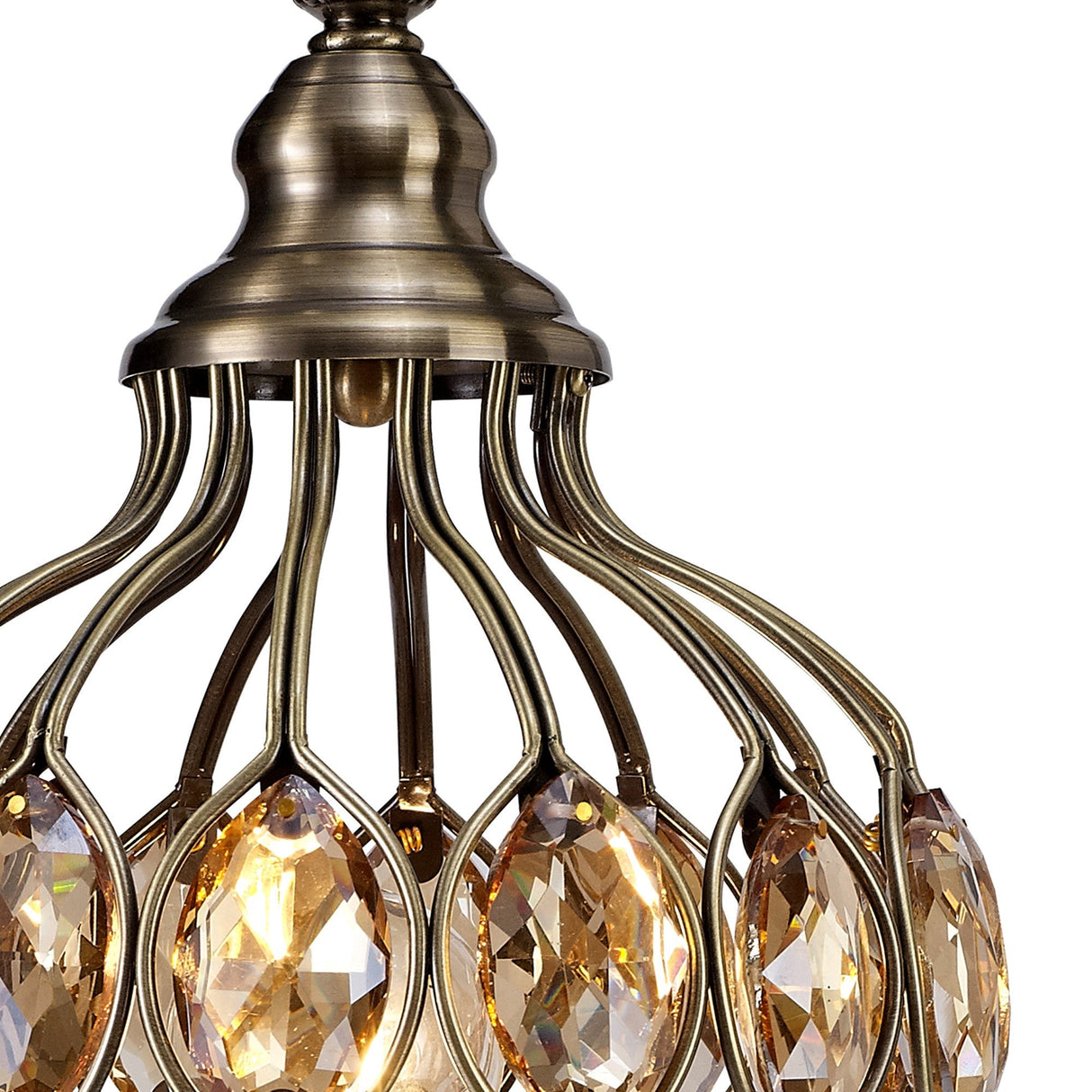 Close-up of the Marisa 1 Light Crystal Table Lamp in antique brass, featuring curved metal arms and amber teardrop-shaped crystals that reflect warm light—a modern take on the classic crystal table lamp.