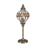 The Marisa 1 Light Crystal Table Lamp features an antique brass finish with an openwork metal cage, amber crystal accents, and a round engraved base—evoking the charm of a Middle Eastern lantern.