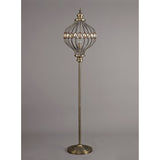 The Marisa 1 Light Crystal Floor Lamp features an antique brass finish, a decorative cage-style metal lampshade with oval accents, and a round base, all set against a plain gray background.