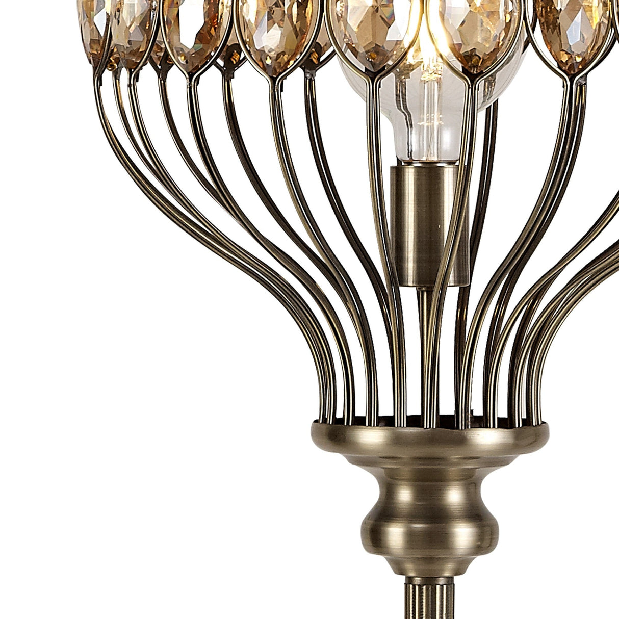 Close-up of the Marisa 1 Light Crystal Floor Lamp in antique brass, featuring a metallic base and multiple curved arms with teardrop-shaped faceted crystal accents around an exposed bulb.