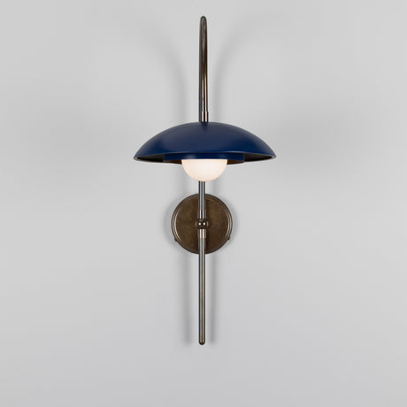 Marrakesh Brass Swan Neck Wall Light with a tall curved arm, round backplate and matt sapphire blue dish shade over a single opal glass globe, on a plain white background.