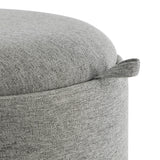 Close-up of the Mashike Stool's grey woven fabric upholstery and padded lid, showing a fabric pull handle and the round drum body.