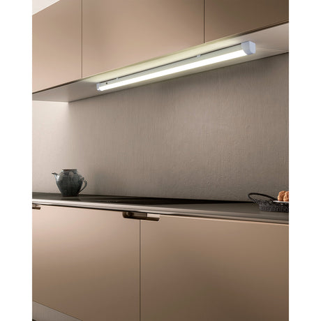 Mattanza LED Flush Ceiling Light, a slim white batten fixture mounted under kitchen cabinetry, illuminating a grey splashback and worktop below.