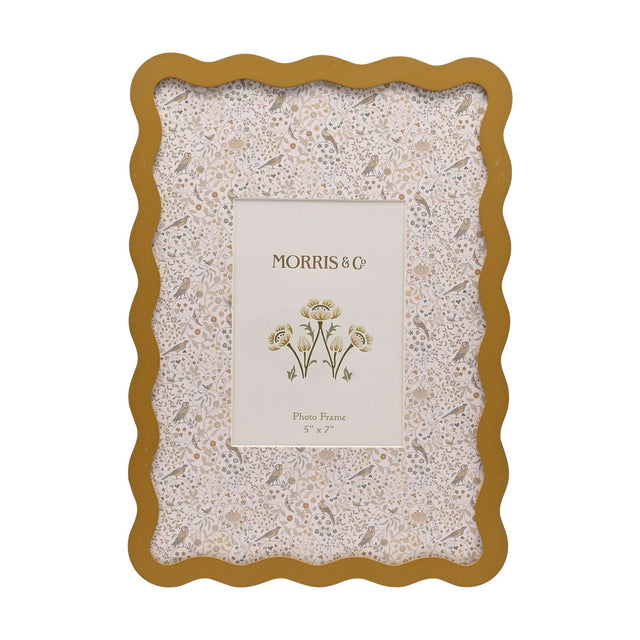 Rectangular metal photo frame with a wavy ochre border, holding a cream mount printed with tiny birds, owls and flowers, for a 7 x 5in photo on a white background.