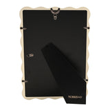 Back view of the Baby Wiggle cream metal photo frame showing a black backing panel, hanging hook, foldout easel stand, and "Morris & Co" branding.