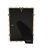 Back view of the Baby Wiggle cream metal photo frame showing the black backing panel, easel stand and hanging hooks on a white background.