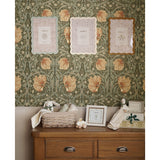 Set of 3 wavy-edged photo frames in cream, soft blue and ochre with patterned borders, holding 7 x 5in prints, displayed on a nursery wall.