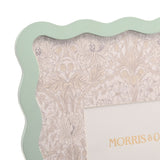 Close-up of a wavy-edged photo frame in sage green MDF with a floral and botanical patterned mount, from the Baby Wiggle set of 3, 7 x 5in.