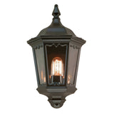 Introducing the Medstead 1 Light Outdoor Wall Light With PIR in Black, a vintage-style lantern ideal for exterior lighting. It features a black finish with a glass cover housing a single glowing bulb and includes decorative elements at the top along with a pointed finial.