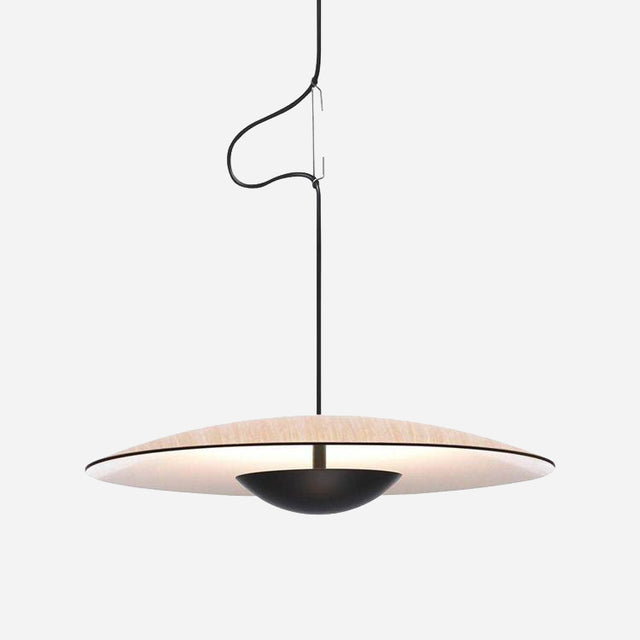 The Ginger LED Small Pendant Light in Black & Oak is a modern masterpiece, showcasing a circular disc-shaped shade suspended from a thin black cord against a white backdrop. This eco-friendly lighting emits a warm glow, and the slightly coiled cord adds an elegant touch.