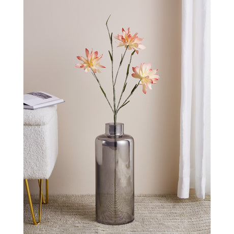 Mehakit Artificial Blossom Spray in cream and pink, three layered blooms on a branching stem, displayed in a grey glass vase in a living room setting.
