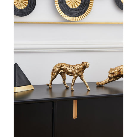 Menjangau Leopard Ornament 17cm in Gold, a textured resin figurine mid-stride with spotted detailing, displayed on a black sideboard beside a matching crouched leopard piece.