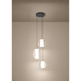 Menorca Glass 3 Light Pendant in black nickel, three staggered egg-shaped clear glass shades with white satin diffusers, shown illuminated against a neutral wall.