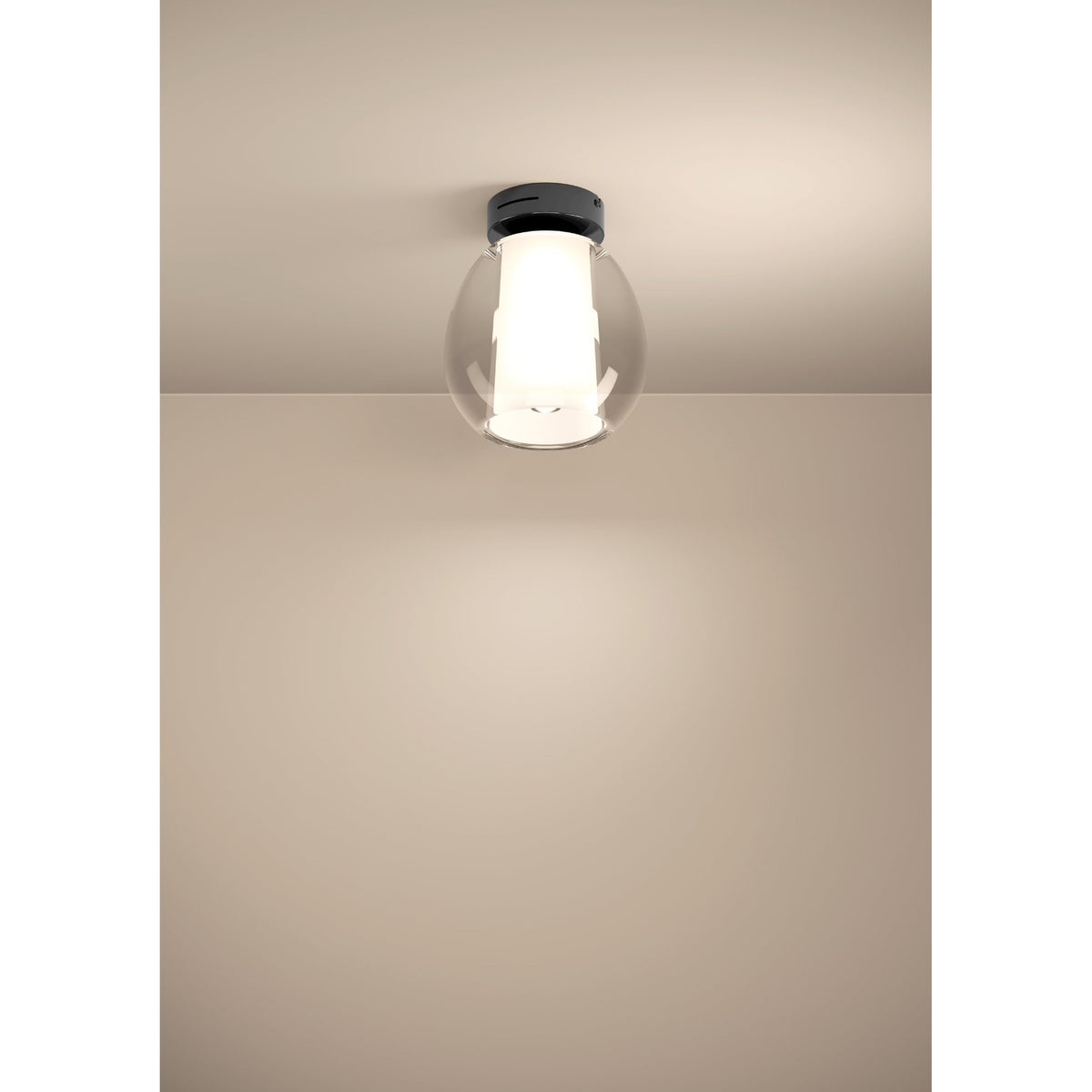 Menorca LED flush ceiling light with black nickel steel canopy and egg-shaped clear glass shade over a white satin glass inner cylinder, illuminated on a neutral ceiling.