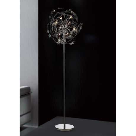 The Messe 12 Light Crystal Floor Lamp in polished chrome features a slim metallic stand and a decorative, starburst-inspired cluster of lights, creating striking ambient lighting against a dark backdrop.