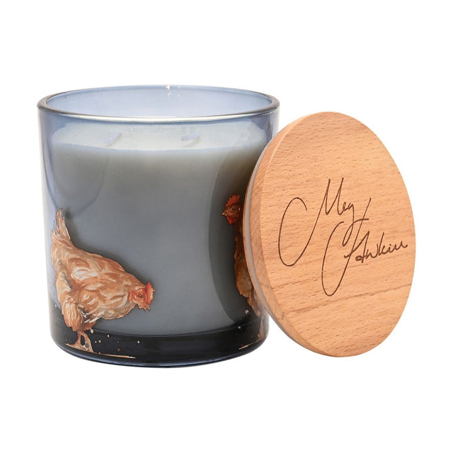 Chickens Honey & Oats 2 Wick Scented Candle in a round smoky grey glass jar painted with russet hens, two wicks visible, with a wooden lid resting beside it on a white background.