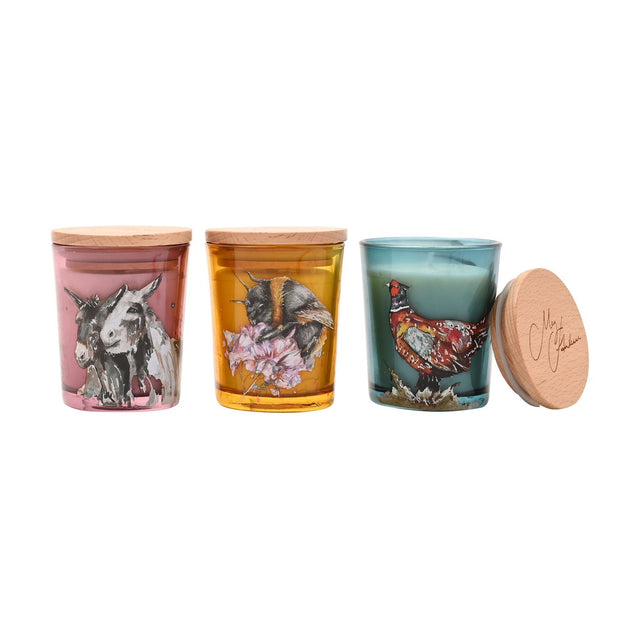 Set of 3 mini round scented candles with wooden lids, in pink with donkeys, amber with a bumblebee and blossom, and teal with a pheasant design, on a white background.