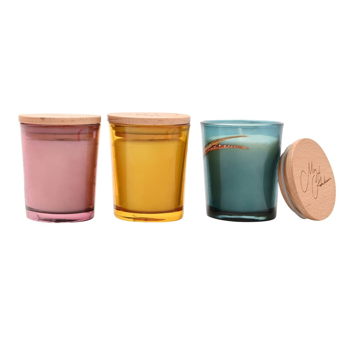 Set of three round mini scented candle jars with wooden lids in pink, amber, and teal glass, shown on a white background, the teal jar's lid resting beside it.