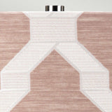Close-up of a textured fabric showcasing geometric patterns in beige and white, complemented by the Milo 1 Light Table Lamp in polished nickel and pink, featuring a metallic fastening detail at the top edge.