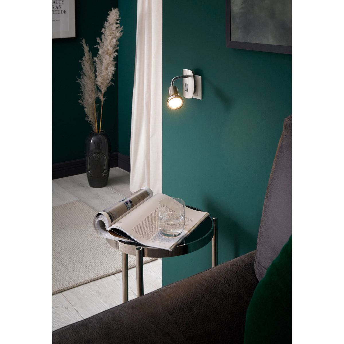 Mini 4 plug-in spotlight with satin nickel backplate, chrome gooseneck arm and GU10 spot head, shown lit beside a sofa and side table in a teal-walled room.