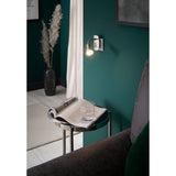 Mini 4 plug-in spotlight with satin nickel backplate, chrome gooseneck arm and GU10 spot head, shown lit beside a sofa and side table in a teal-walled room.