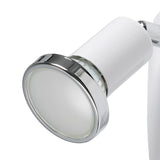Close-up of the Mini 4 plug-in spotlight's white cylindrical head with polished chrome ring and GU10 bulb, mounted on a white arm against a plain background.