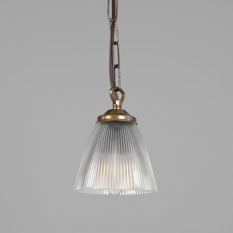 Mirovel Ribbed Glass Pendant Light with a cone-shaped ribbed glass shade, brass gallery and hook, hung from a chain against a plain grey background.